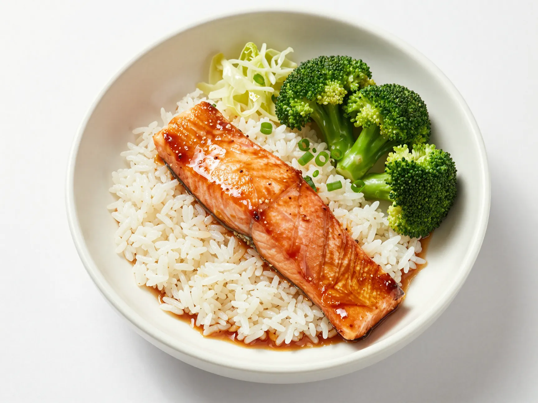 Glazed teriyaki salmon fillet on a steamed rice bowl