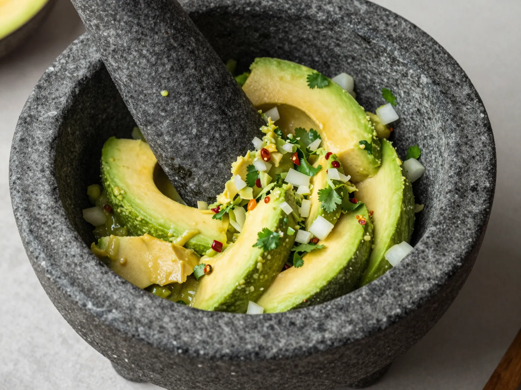 Use a molcajete or fork never a food processor